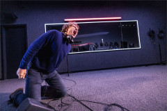 Lucas Iverson kneels, screaming, in A Ghost in Your Ear. Photo by Matthew Murphy