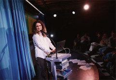 Rachel Kaly at a lectern set on a medical cart in Hospital Hour. Photo by Emilio Madrid