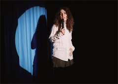 Rachel Kaly in a spotlight, her shadow on the curtain, in Hospital Hour. Photo by Emilio Madrid