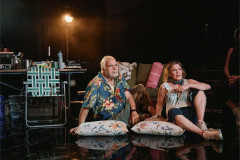 Michael Mulheren and Victoria Clark sitting on cushions on the floor of the research tent in Human Things at the West End Theatre. Photo by Emilio Madrid