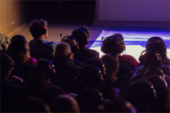 Audience members wear Auracast-enabled headphones at Love Me at SoHo Playhouse. Photo by Curtis Brown