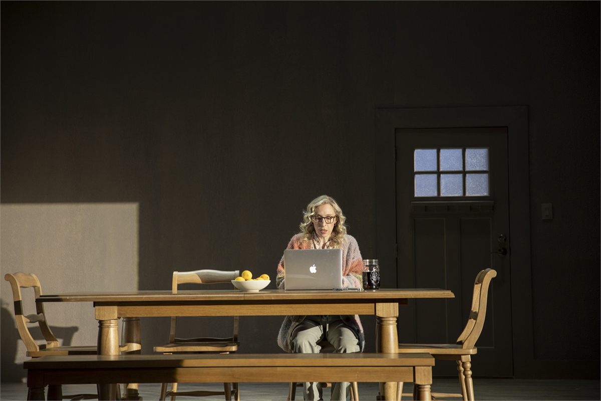 Crystal Finn as Jeanie at her laptop in Anon at MCC Theater
