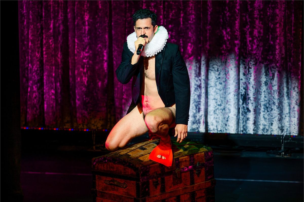 Damien Warren-Smith as Garry Starr perched on a trunk in Garry Starr: Classic Penguins at Studio Seaview. Photo by Austin Ruffer