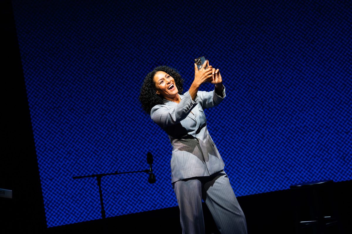 Sarah Jones holds up a phone as the character America in America, Who Hurt You?. Photo by HanJie Chow Sarah Jones holds up a phone as the character America in America, Who Hurt You?. Photo by HanJie Chow