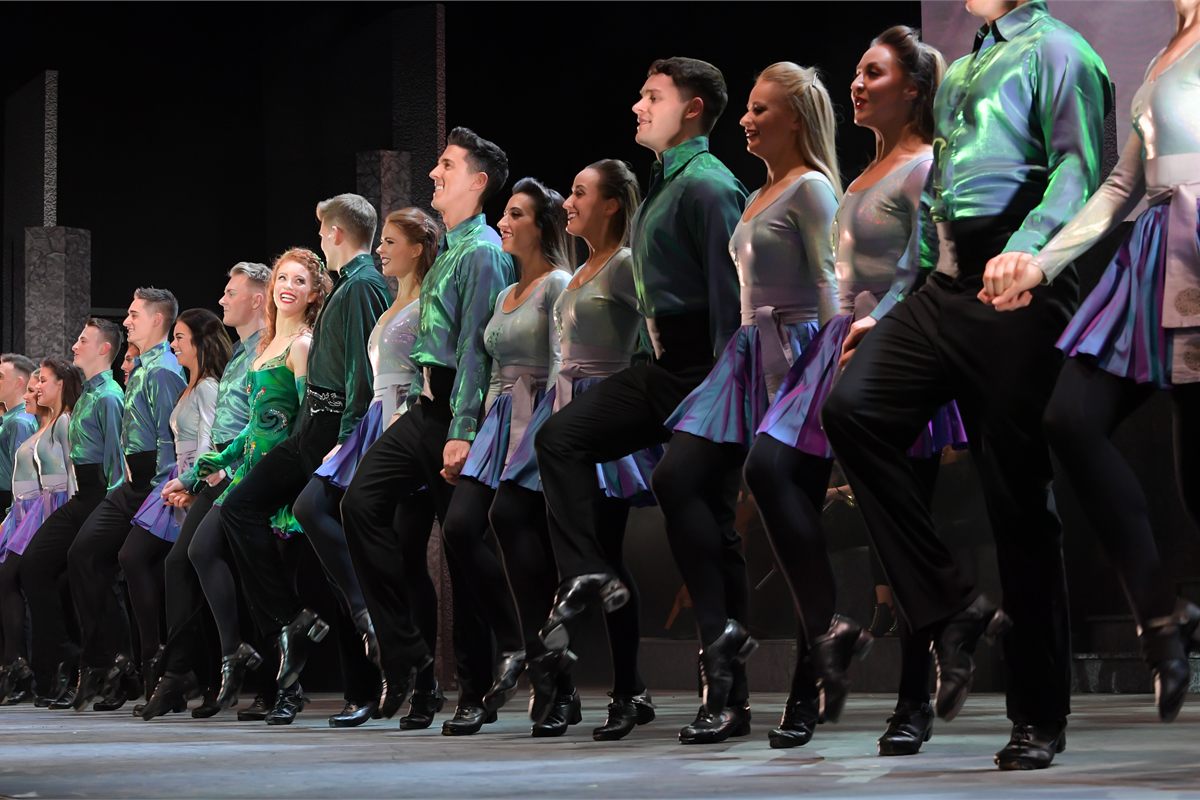 The company of Riverdance 30 – The New Generation in the show's famous line of dancers