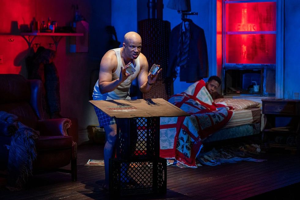 Glenn Davis at the three-card monte table in Topdog/Underdog. Photo by Michael Brosilow