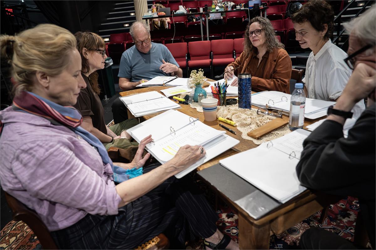 The company of We'll See around the table in rehearsal at The Public Theater. Photo by Joan Marcus